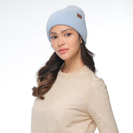 Woman wearing a light blue beanie with a logo on a white background