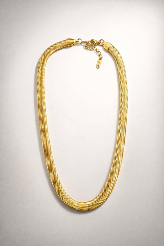 Chunky gold herringbone necklace with a smooth flat design and high-shine polished finish
