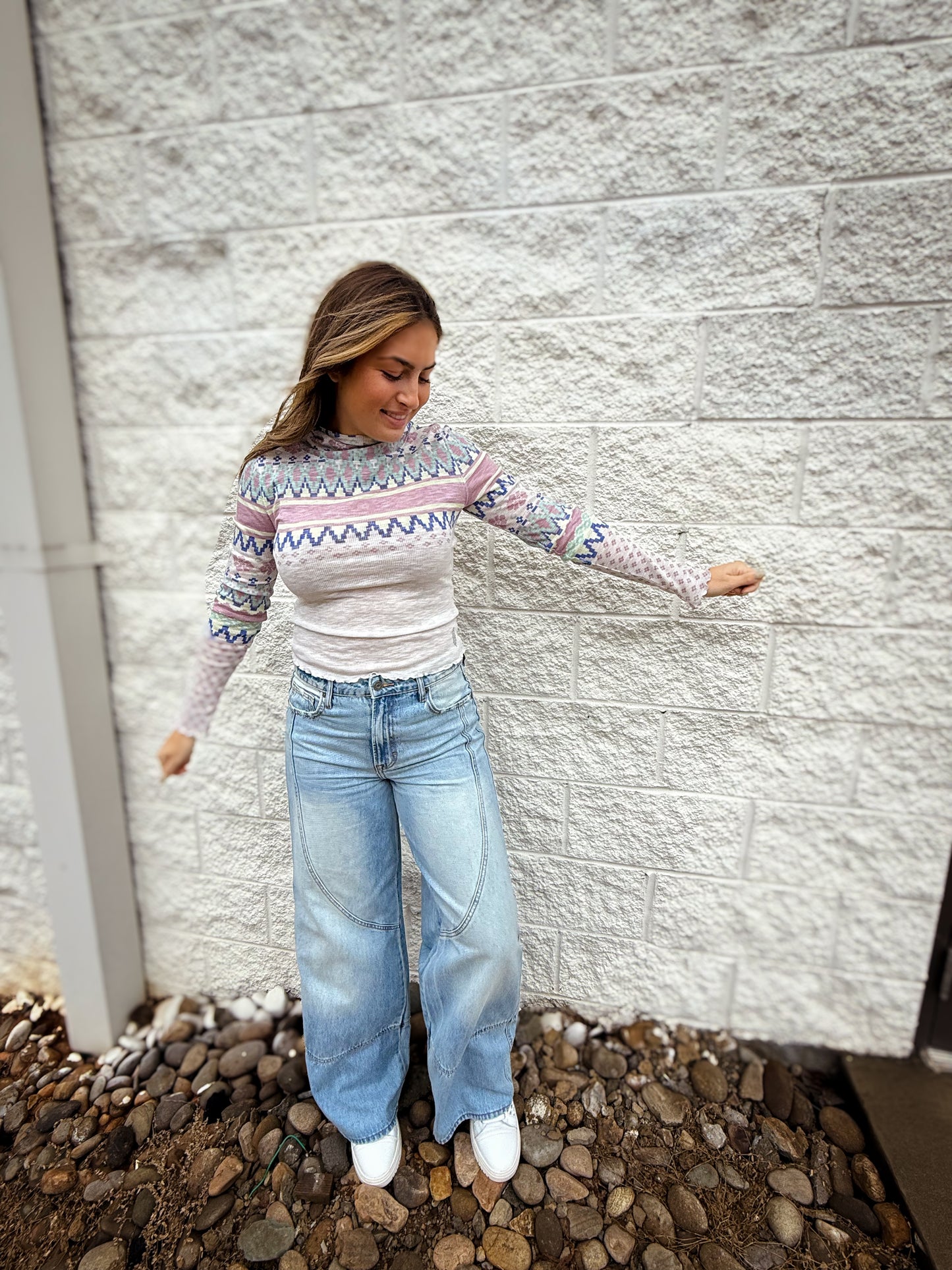 patterned ribbed long sleeve top with lettuce trim and hood paired with denim.