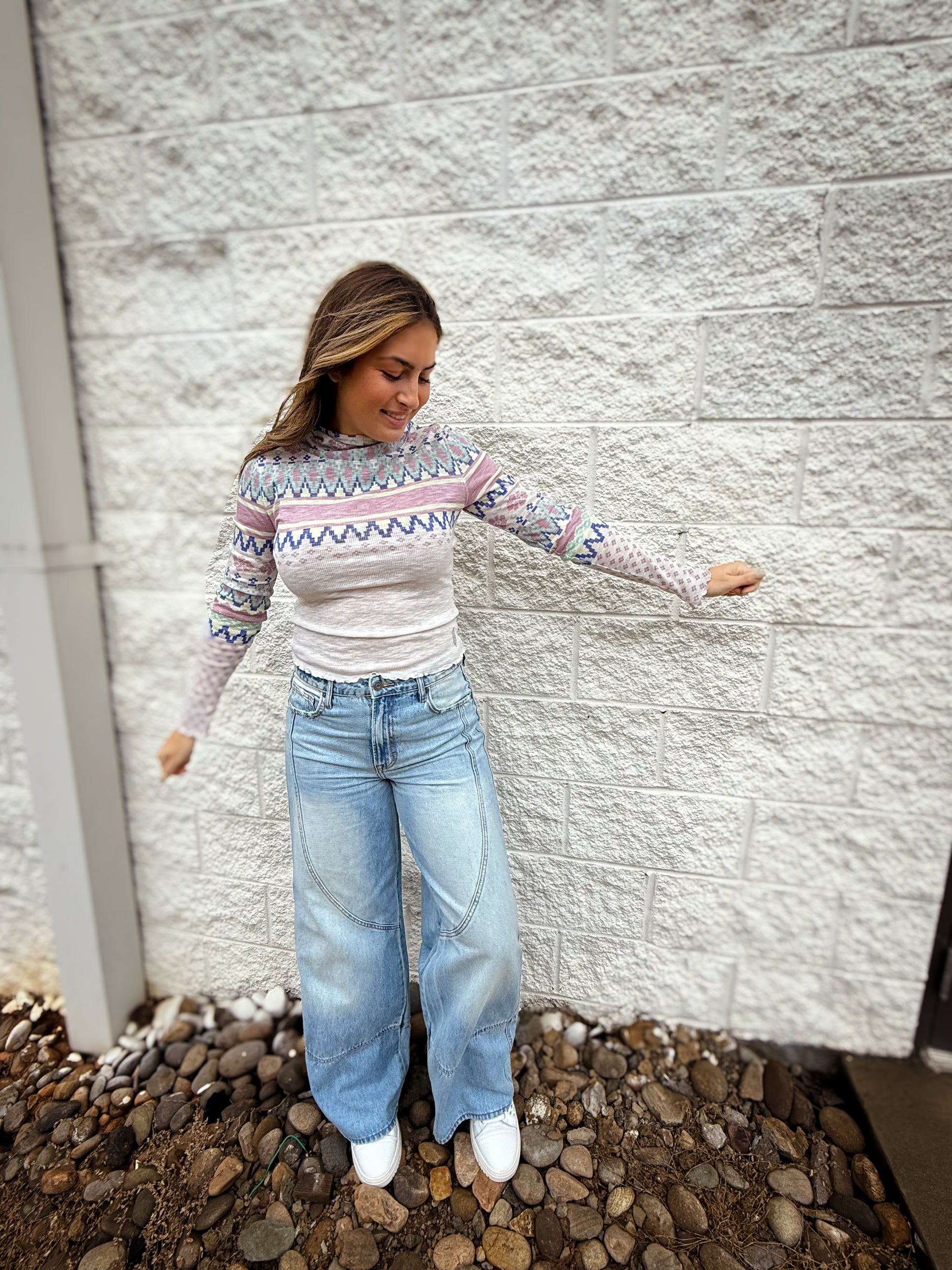 patterned ribbed long sleeve top with lettuce trim and hood paired with denim.