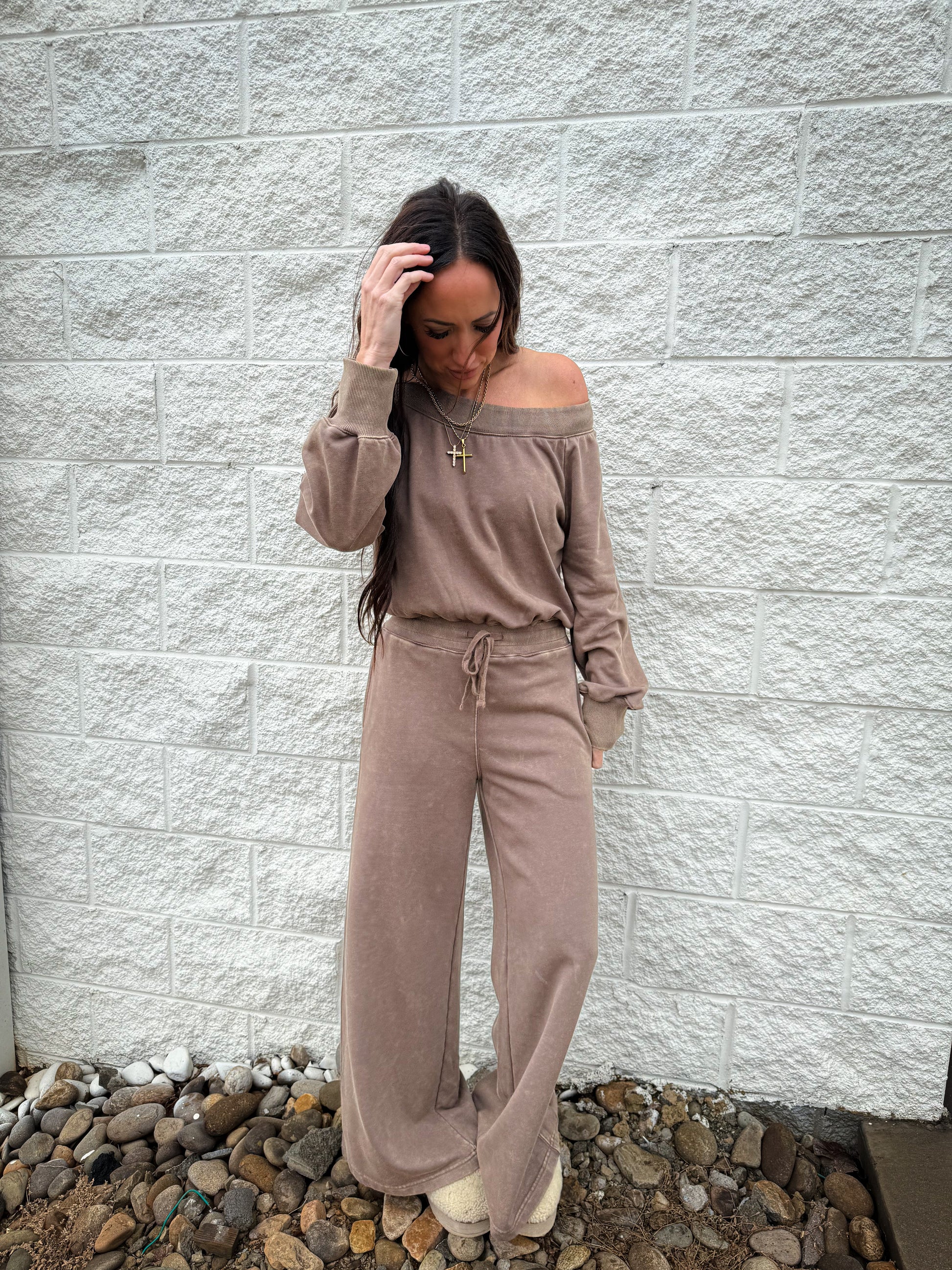 Brown jumpsuit worn off the shoulder 