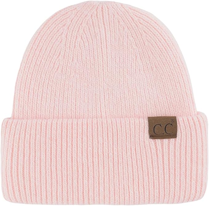 Pink beanie with a brown label on a white background
