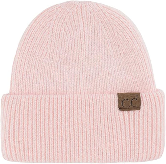 Pink beanie with a brown label on a white background