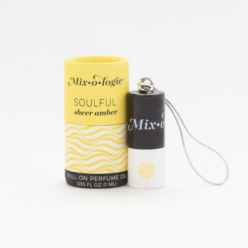Mixologie Soulful Sheer Amber roll-on perfume oil with yellow and white wavy-patterned packaging and small black cap container