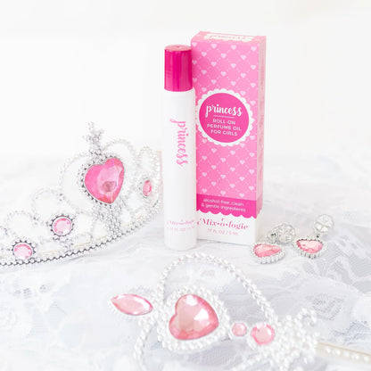 Roll-on perfume oil for girls with packaging and decorative elements on a white background