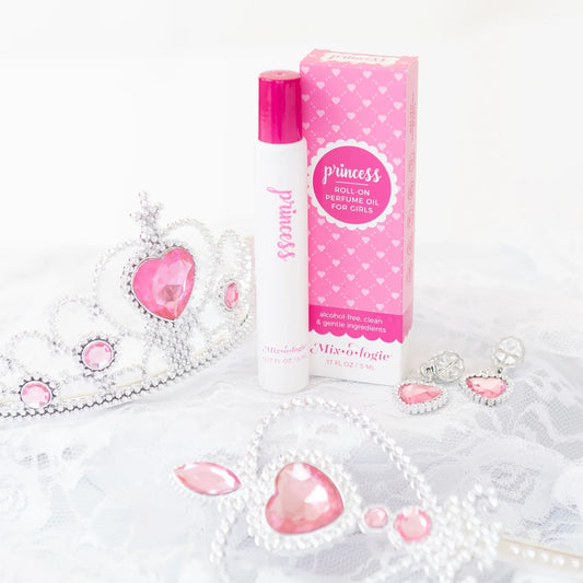 Roll-on perfume oil for girls with packaging and decorative elements on a white background