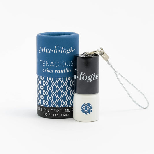 Mixologie Tenacious Crisp Vanilla roll-on perfume oil with blue patterned packaging and small white bottle with black cap and silver strap