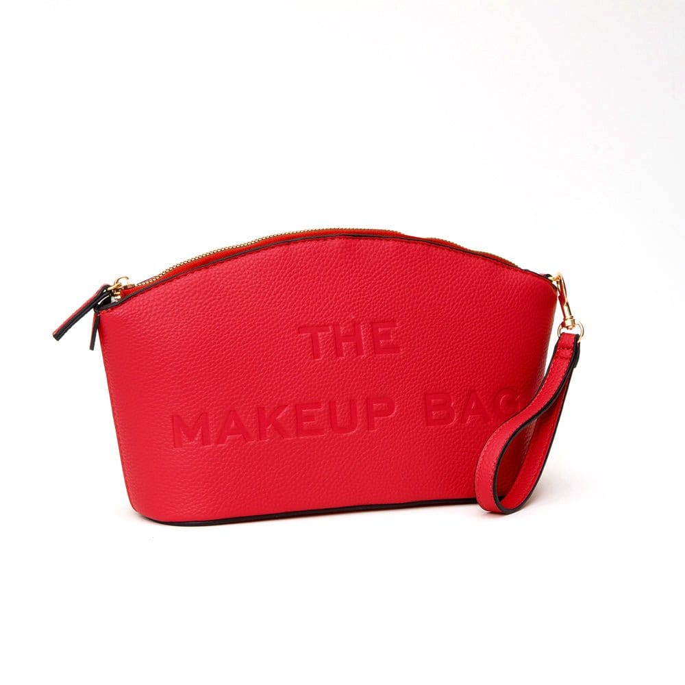 Red makeup bag featuring “THE MAKEUP BAG” embossed on the front