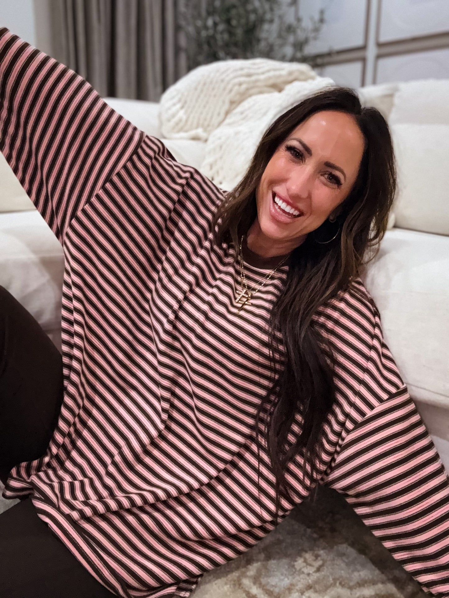 Pink and brown striped oversized long-sleeve pullover made from soft, cozy fabric