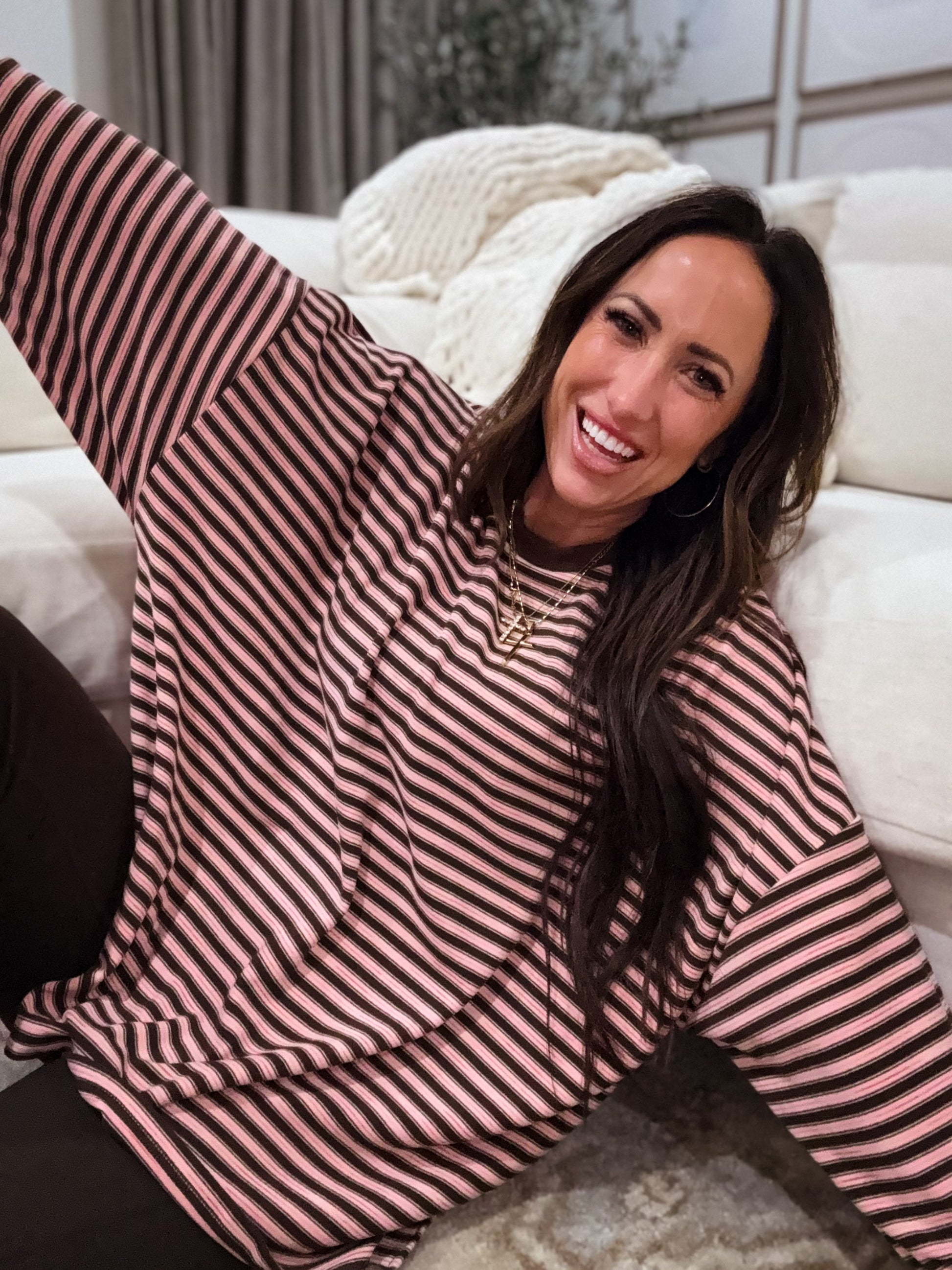 Pink and brown striped oversized long-sleeve pullover made from soft, cozy fabric