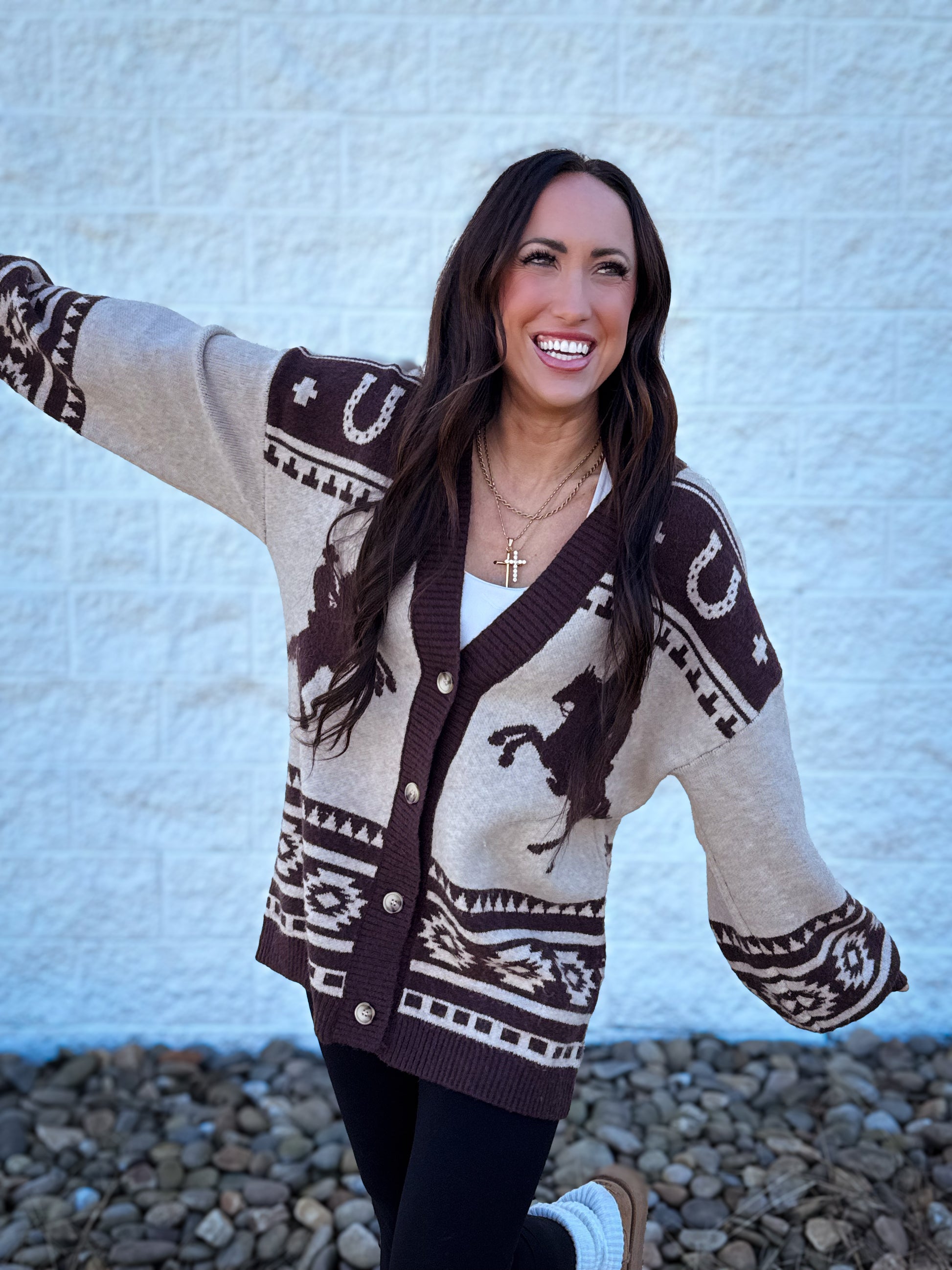 Woman wearing a patterned cardigan with a white background
