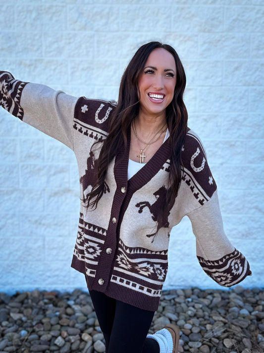 Woman wearing a patterned cardigan with a white background