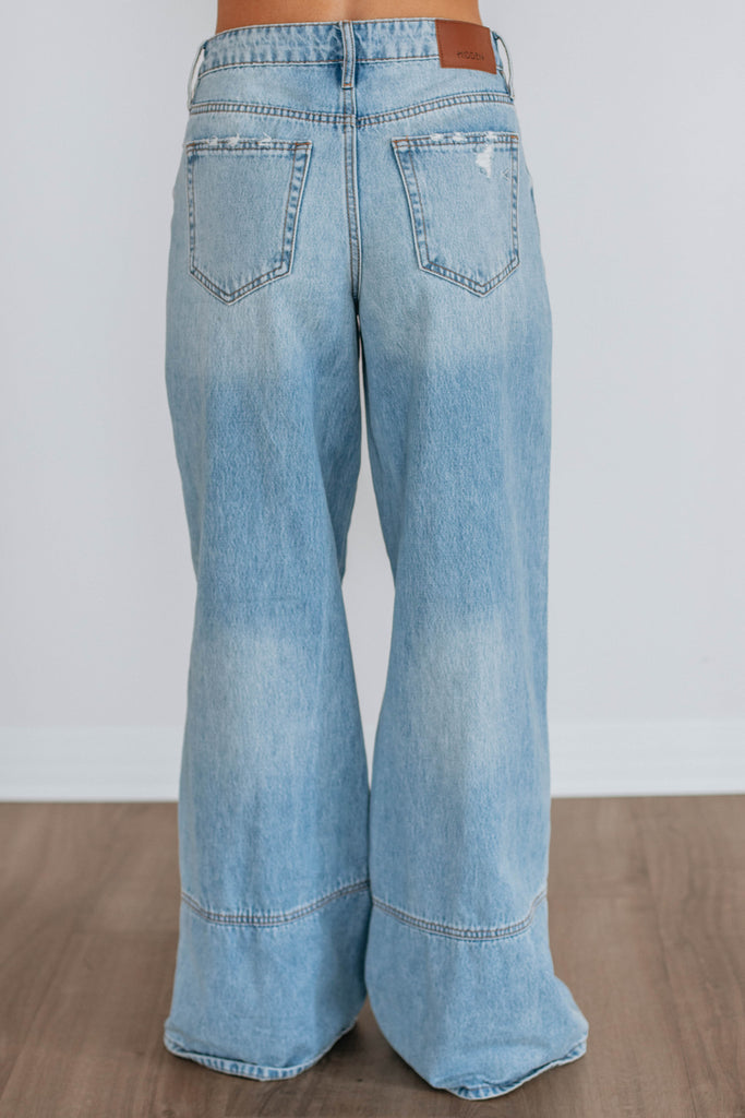 Light wash wide leg denim with curved seams 