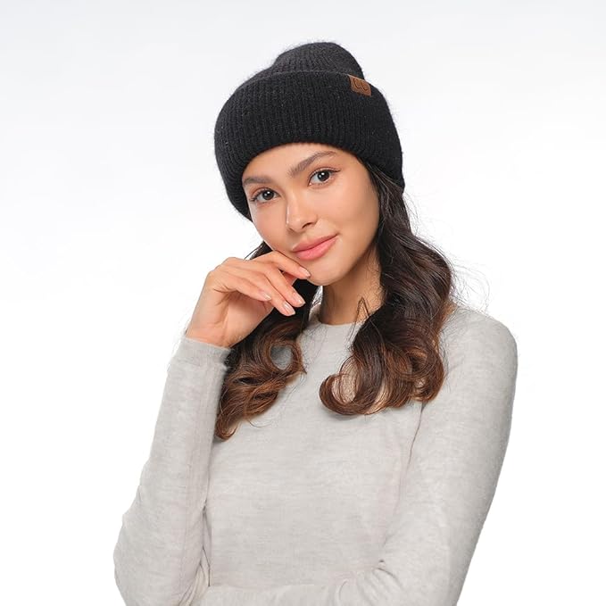 Woman wearing a black beanie and gray sweater on a white background