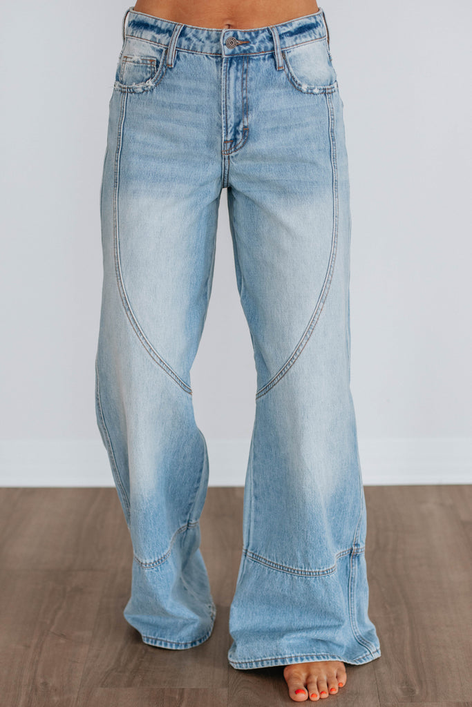 Light wash wide leg denim with curved seams 