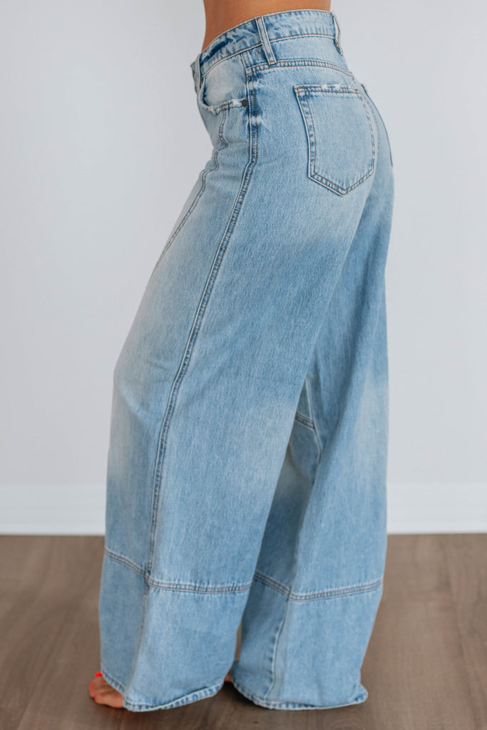 Light wash wide leg denim with curved seams 
