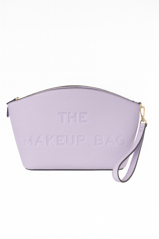 Lavender makeup bag featuring “THE MAKEUP BAG” embossed on the front