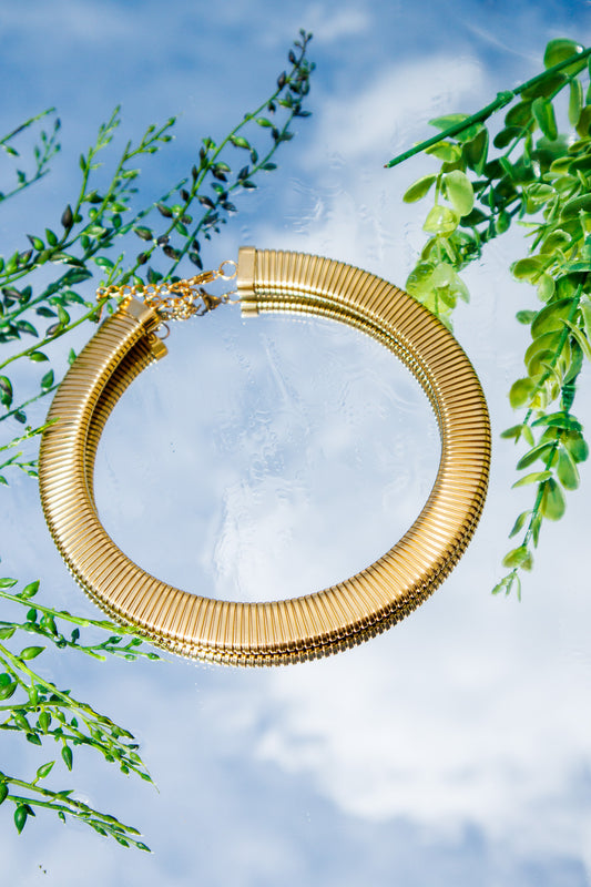 Large gold herringbone necklace with a flat, high-shine polished chain design