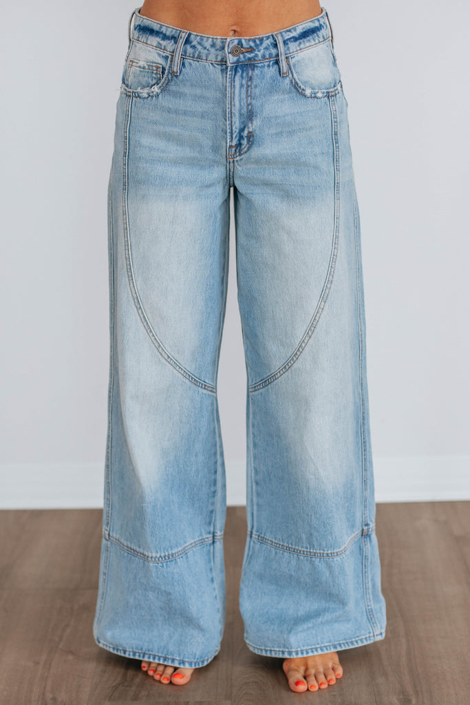 Light wash wide leg denim with curved seams 