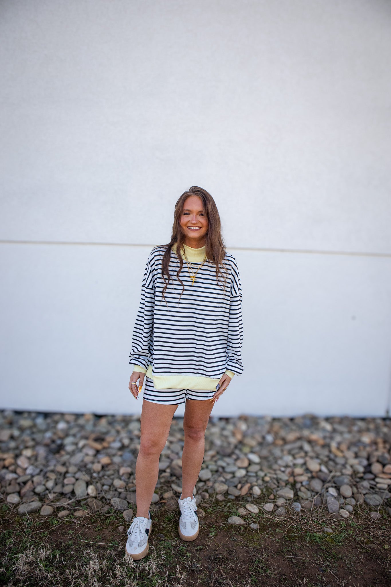 Shop the Banana Cream Striped Lounge Set. Featuring an oversized pullover & high-rise pocketed shorts, it’s the ultimate outfit for effortless, everyday style.