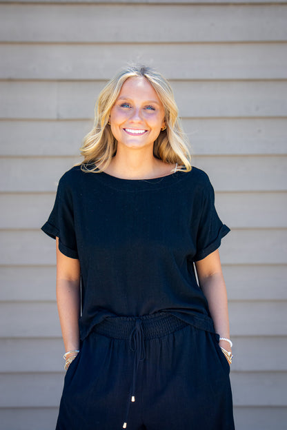 Women’s black linen blend short sleeve top with relaxed boxy fit styled with matching black drawstring pants.
