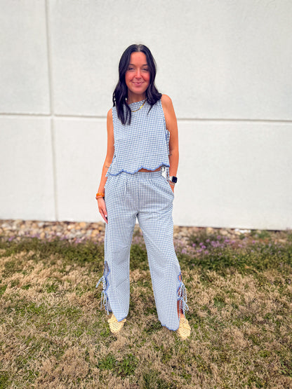 Elevate your style with Bluebell Gingham Scallop Pants. Breathable cotton-linen, chic side ties, and a wide-leg fit. Perfect for beach days and brunch!