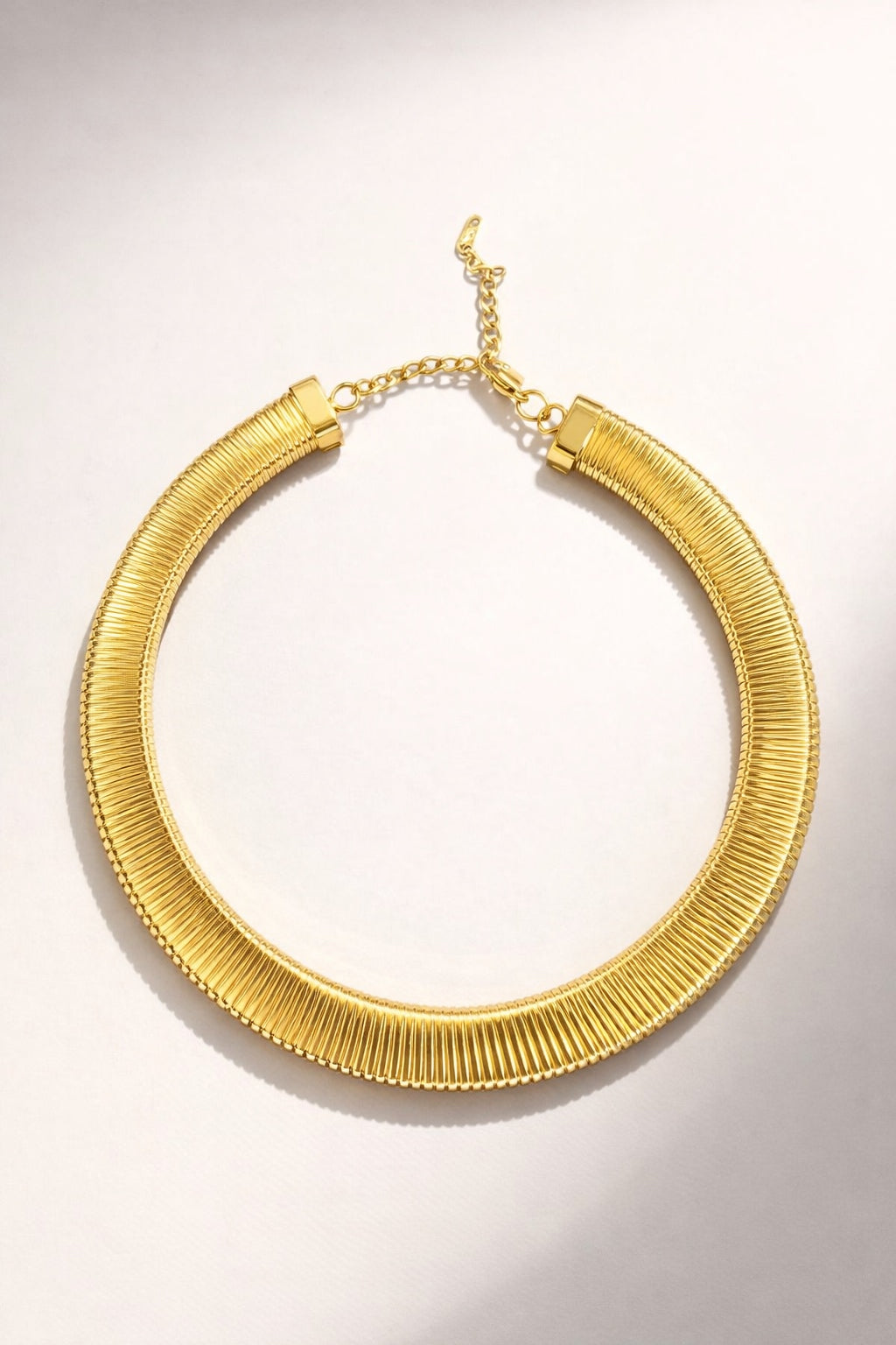 Large gold herringbone necklace with a flat, high-shine polished chain design