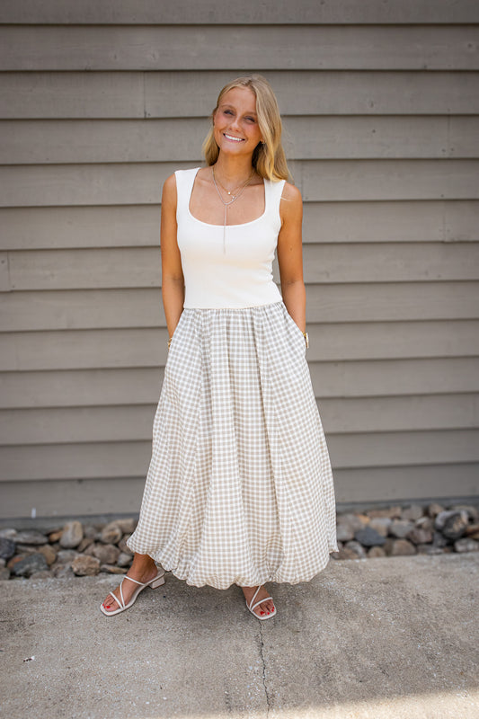 Glow in our Coastal Charm Gingham Bubble Dress. Featuring a fitted tank & flowy maxi skirt, it's perfect for brunch or vacation. Shop the ultimate summer look!