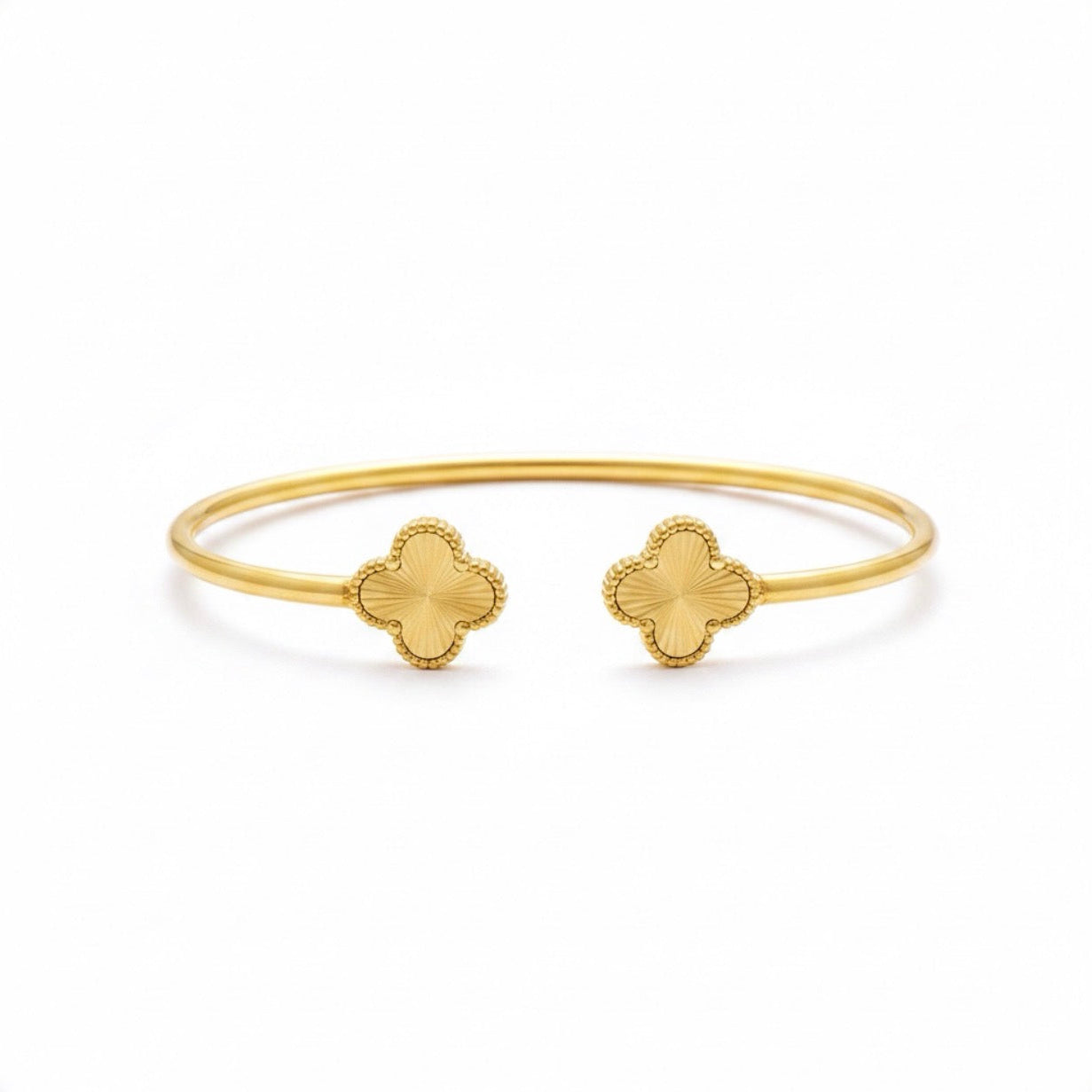 Trendy Covenant clover cuff bracelet in gold with open cuff design and clover ends, minimalist elegant jewelry