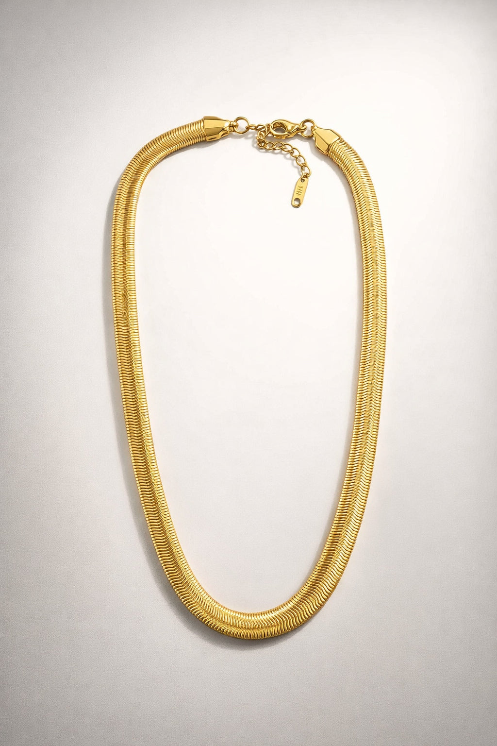 Chunky gold herringbone necklace with a smooth flat design and high-shine polished finish