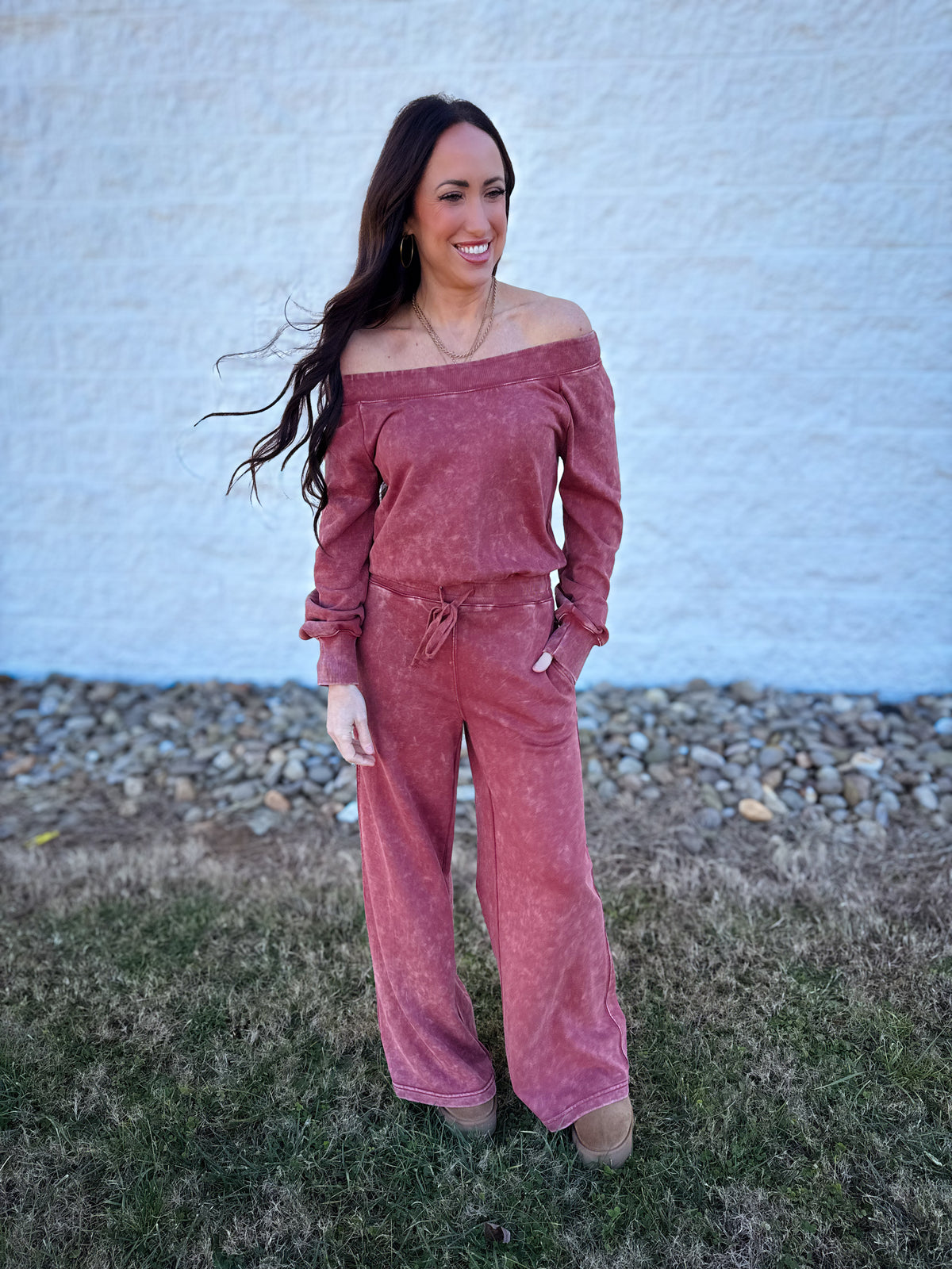 Model wearing a mineral wash off-the-shoulder long sleeve lounge set in vintage rose featuring a relaxed top, drawstring wide-leg pants, and side pockets.
