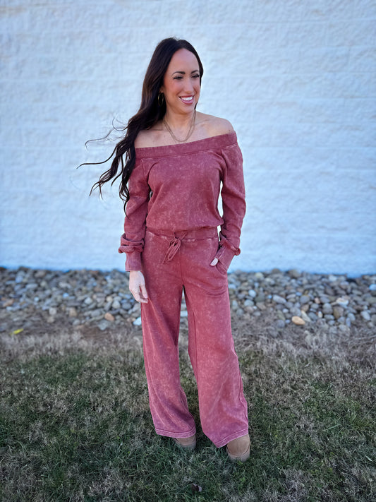Model wearing a mineral wash off-the-shoulder long sleeve lounge set in vintage rose featuring a relaxed top, drawstring wide-leg pants, and side pockets.