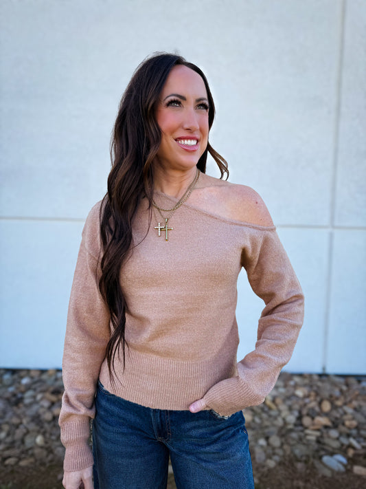 Woman wearing an off the shoulder  beige sweater 
