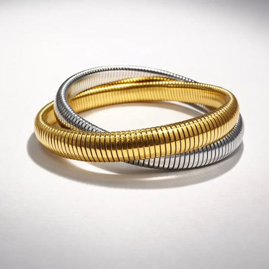 Trendy two-tone gold and silver coil bracelet, flexible wrap style with textured finish
