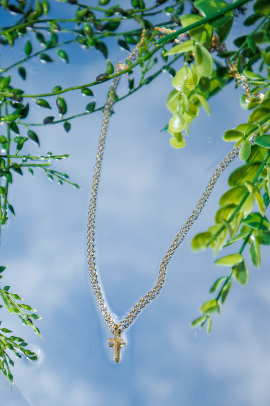 Dainty gold cross necklace featuring a polished gold cross pendant on a delicate adjustable chain, faith-inspired everyday jewelry for women.