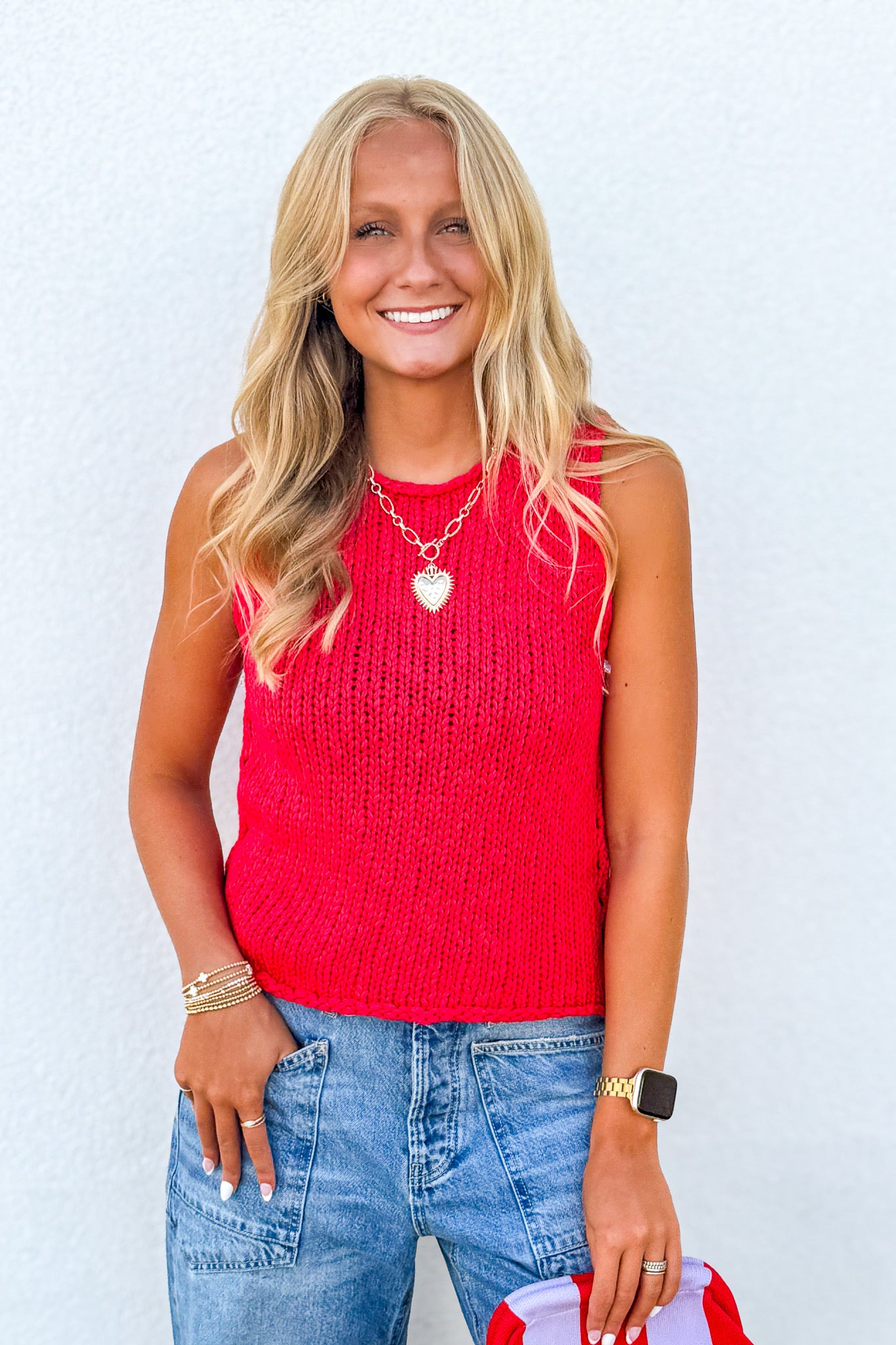 Free People Opal Knit Tank in Sour Sweet Red styled with denim jeans, featuring a sleeveless crochet knit design and bright summer color.