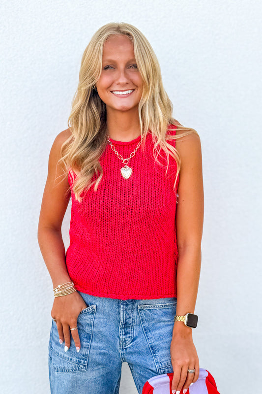 Free People Opal Knit Tank in Sour Sweet Red styled with denim jeans, featuring a sleeveless crochet knit design and bright summer color.