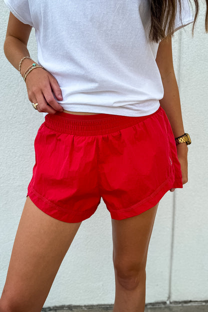 Shop Free People On The Go Run Shorts in Victory Red. Sweat-wicking, low-rise, and lightweight with built-in briefs—perfect for runs and lifestyle. Order yours now!
