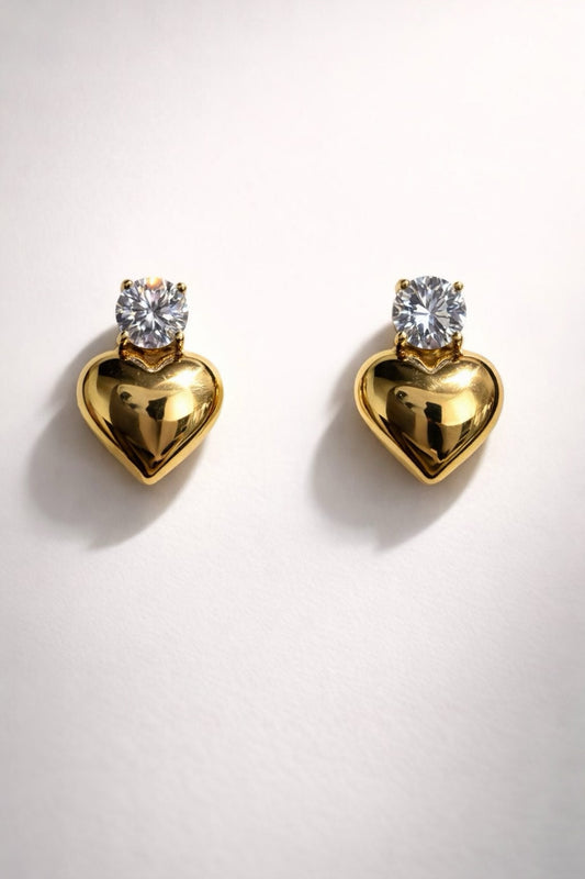 Gold heart-shaped stud earrings with crystal stud. 