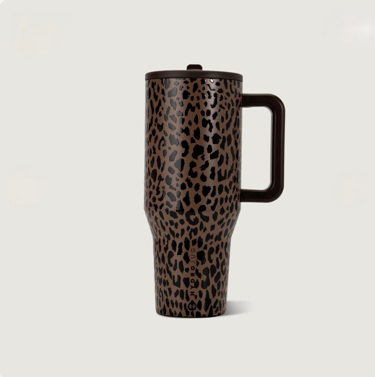 Brown leopard print insulated leak proof tumbler with black spots, a matching dark brown handle, and lid in a tall travel cup design.