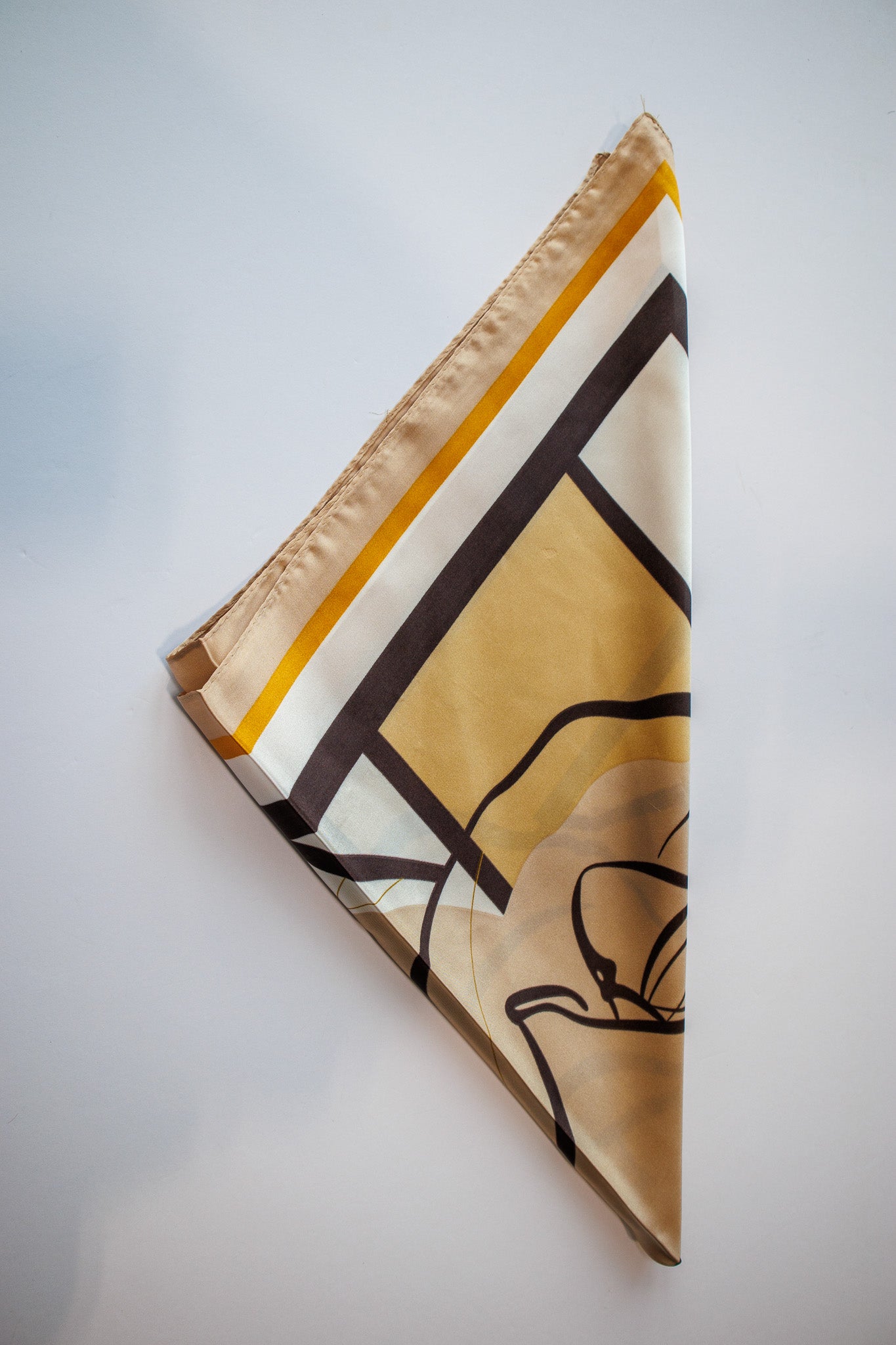 Decorative scarf with geometric pattern on a light gray background