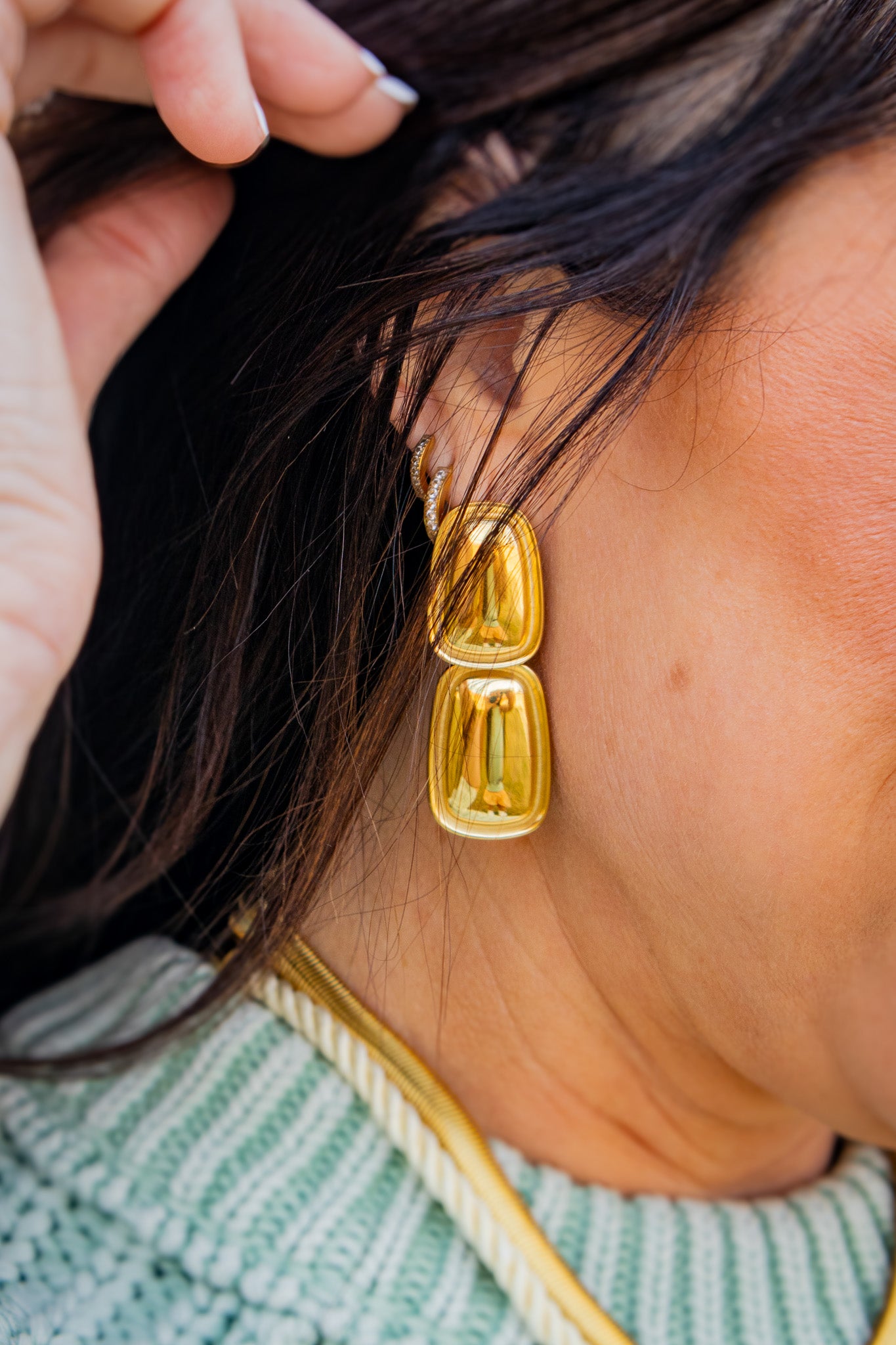 Gold rectangular statement earrings with a glossy, high-shine finish