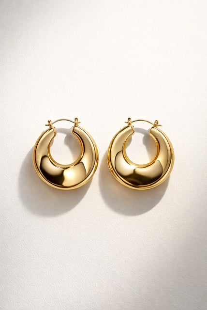 Trendy gold hoop earrings, thick rounded design with a smooth high-polish shine