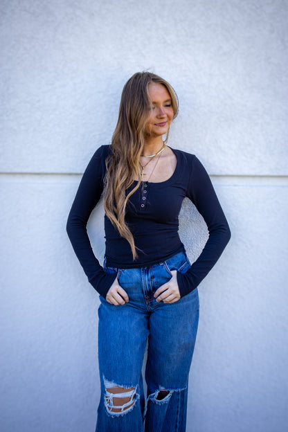 black fitted long sleeve with button front closure  and side slits