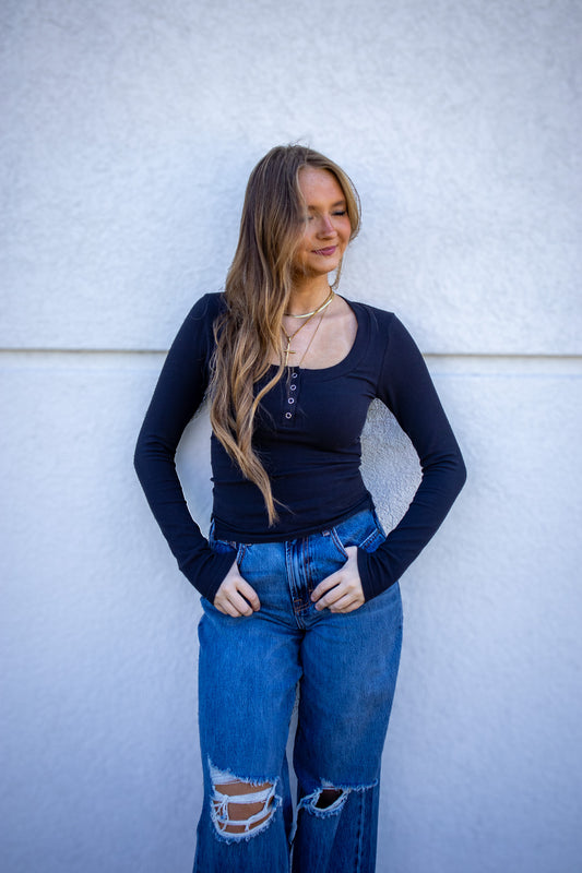 black fitted long sleeve with button front closure  and side slits