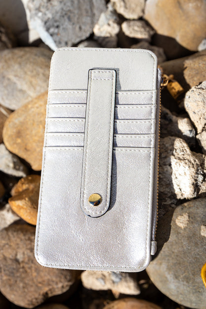 Silver wallet on a rocky surface