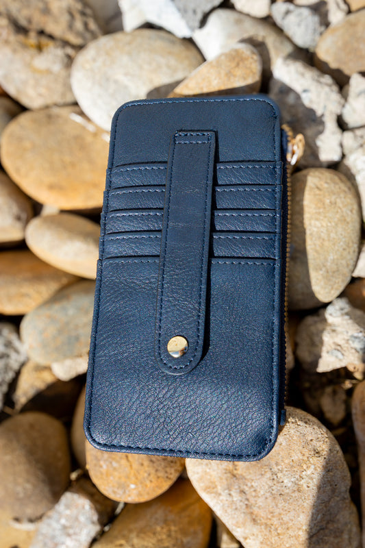 Blue leather wallet on a bed of stones
