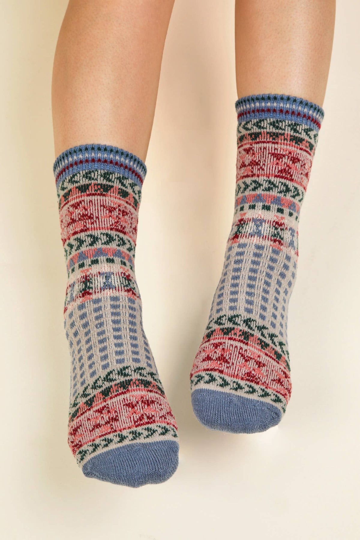 Pair of patterned socks on a plain background