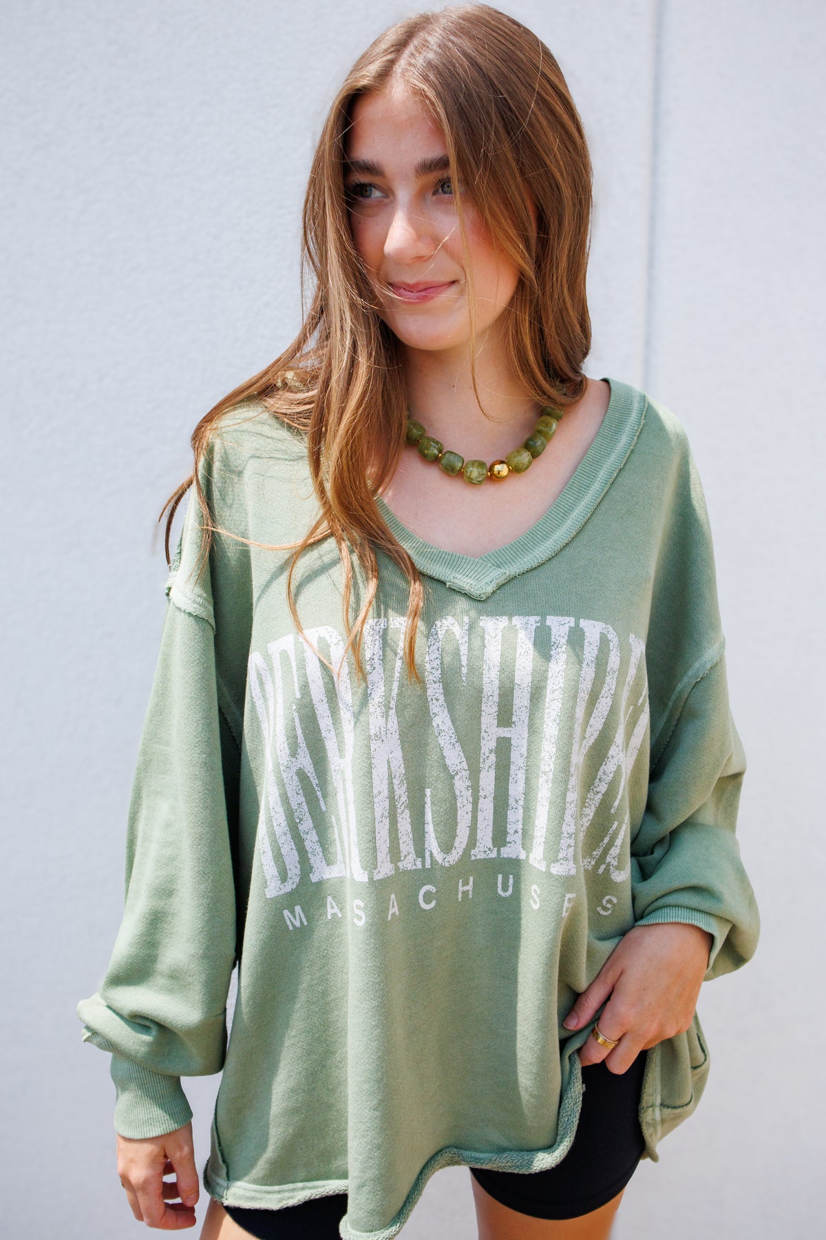 Oversized vintage wash olive green "Berkshire, Massachusetts" graphic sweatshirt featuring a relaxed fit, distressed neckline, dropped shoulders, and long sleeves for a cozy, laid-back everyday look.