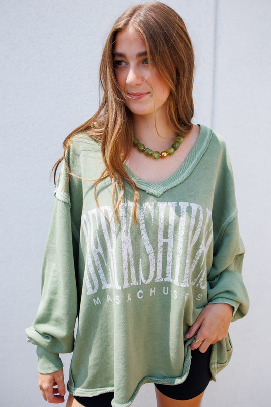 Oversized vintage wash olive green "Berkshire, Massachusetts" graphic sweatshirt featuring a relaxed fit, distressed neckline, dropped shoulders, and long sleeves for a cozy, laid-back everyday look.